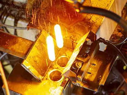 Bright orange molten metal during industrial machining process